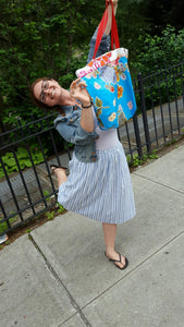 Customer kicking up her heels and showing her market bag from Tallulah ArtHead