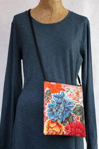 Orange oilcloth cross-body bag from Tallulah Art•Head on mannequin