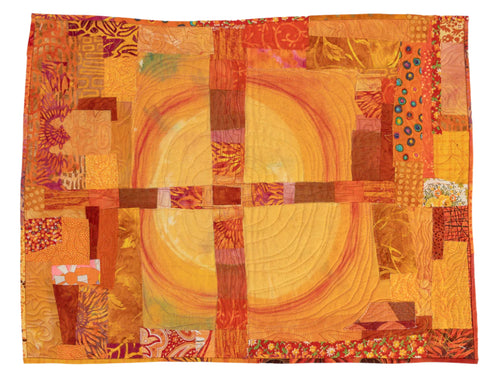 Colorful quilt with orange and yellow patterns.